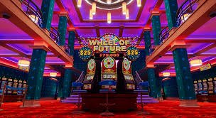 Live casino dealer table with multiple game options on screen